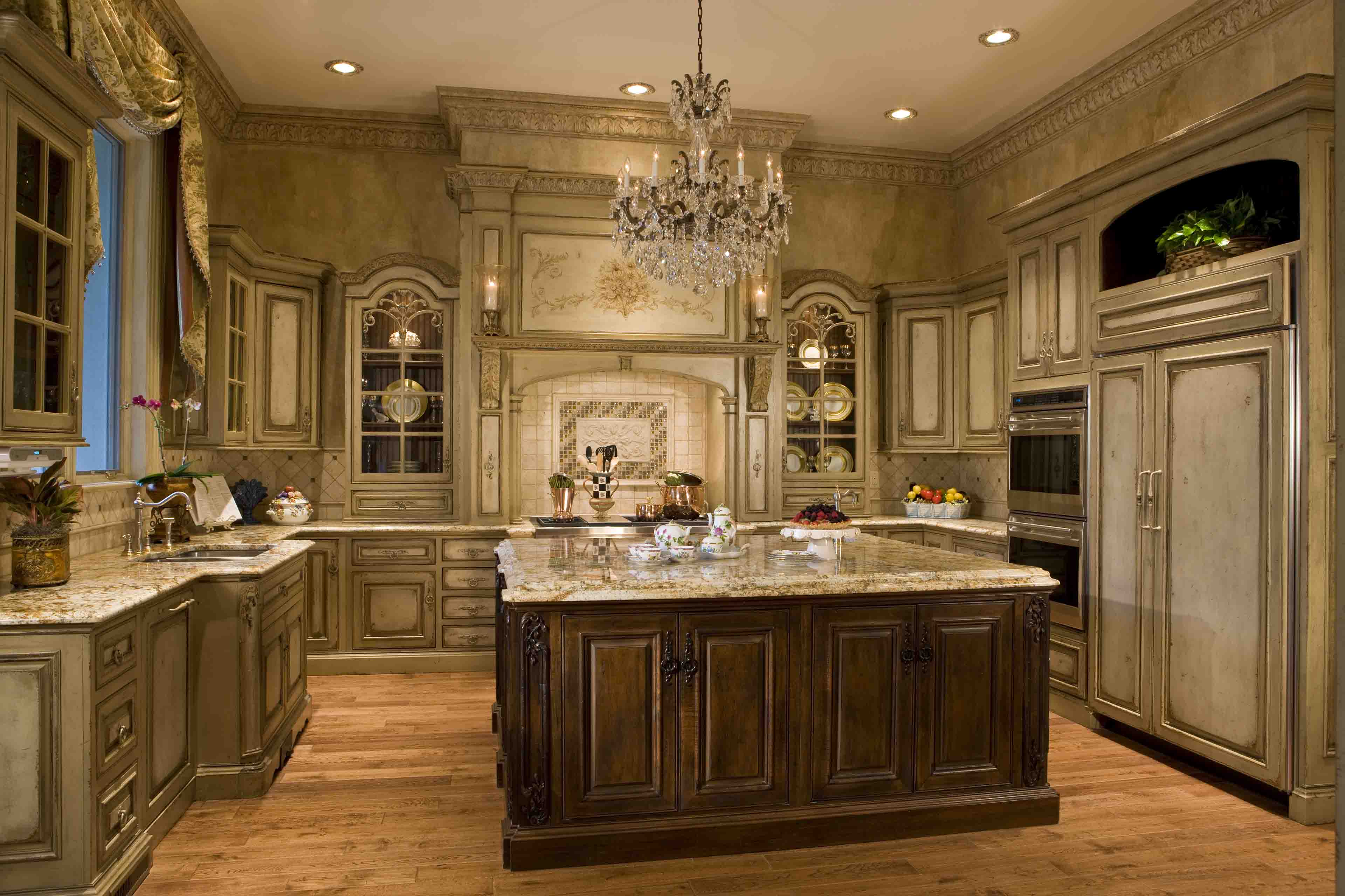 Antique Luxury, custom, gourmet kitchen with large island in neutral colors and crystal chandelier