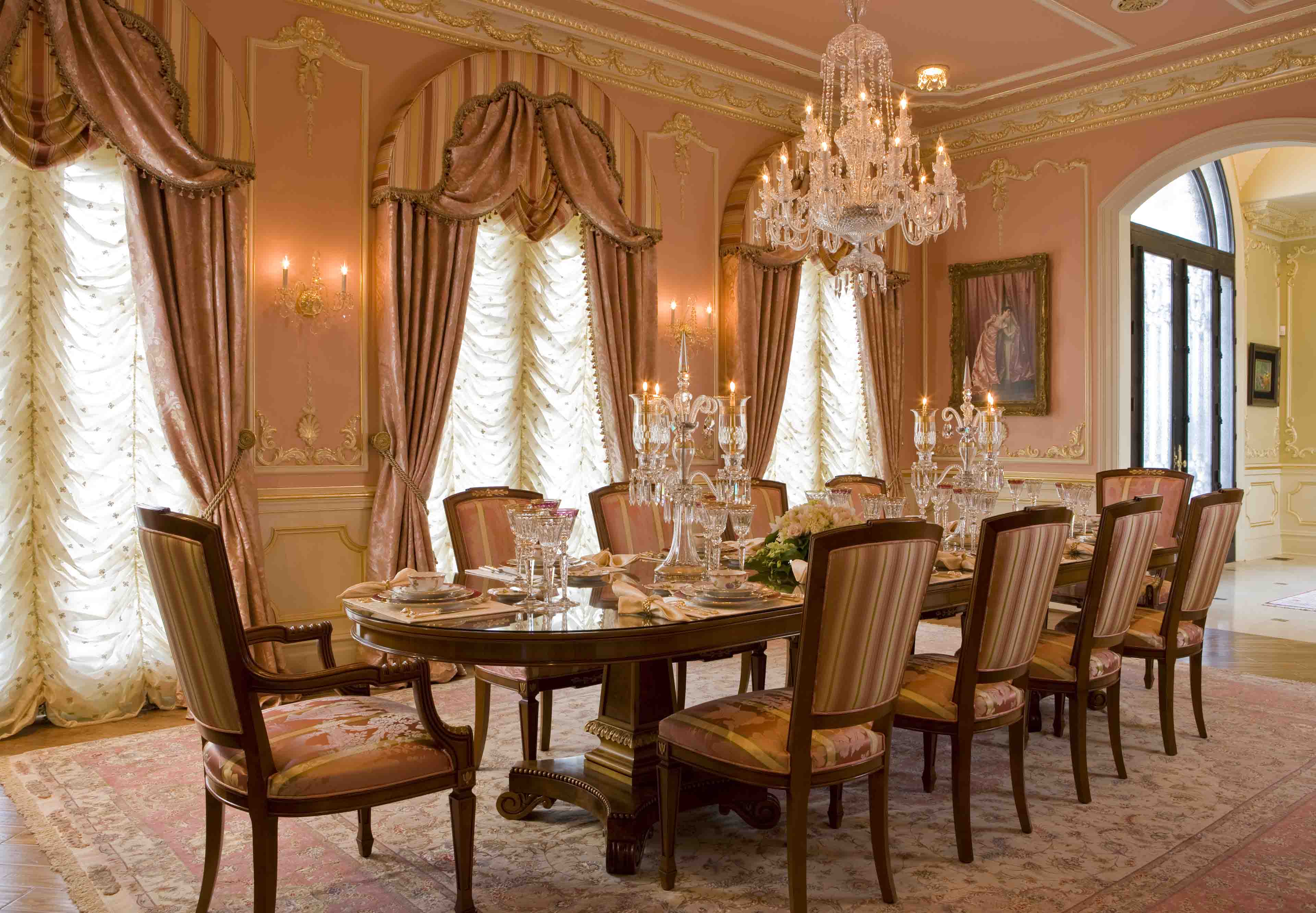 Pink dining room with fancy plate settings in luxury residential property