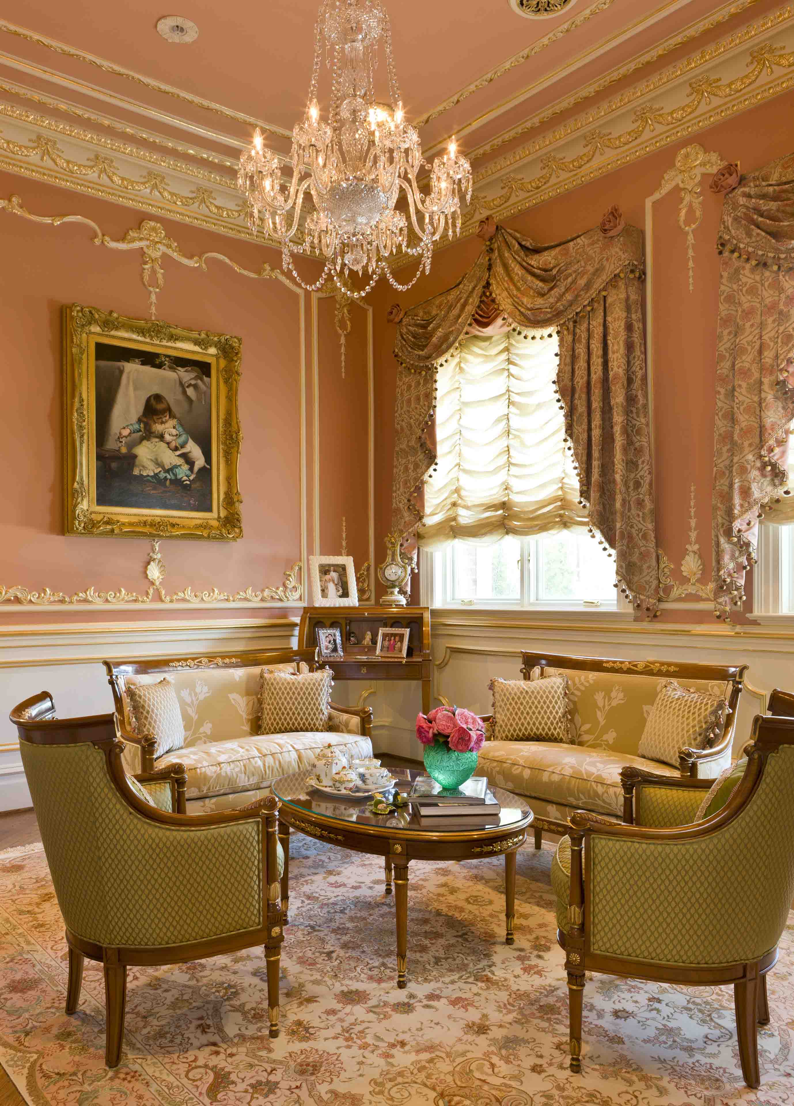 Tea room with classical furniture, custom pink walls and gold crown moldings